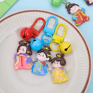 Close-up detail shot of cute Tang dynasty style cartoon princess resin keychains with bells.