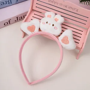Cute pink plush bunny headband with heart decor for face washing and daily makeup routines.