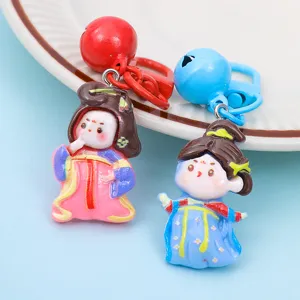 Detailed view of cute cartoon Chinese Tang suit princess resin keychain pendant with colorful bells.