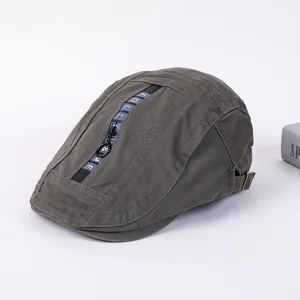 Detailed view of the stylish dark gray flat cap with a decorative zipper stripe and unique design.