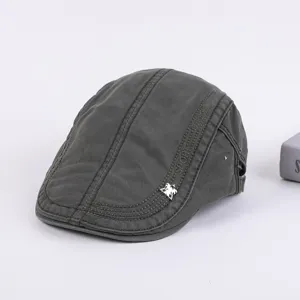 Detailed view of dark grey men cotton flat cap, classic ivy beret hat with sporty embroidery.