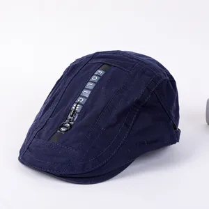 Detail view of dark blue flat cap with zipper and letter print, stylish streetwear beret hat.