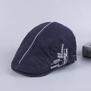Closeup detail of dark blue cotton ivy cap featuring central grey stripe and side embroidery text.