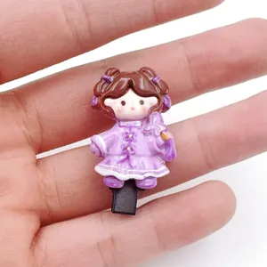 Close-up of cute cartoon character hair clip with purple ethnic outfit, delicate details.