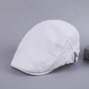 White cotton flat cap for men, retro newsboy style hat with side tag, casual vintage headwear.