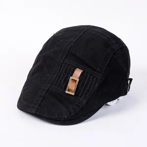 Detail view of a black cotton flat cap, stylish leather buckle, vintage street style hat.