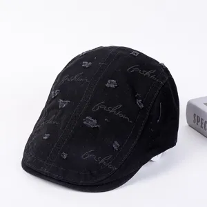 Black distressed flat cap with fashion embroidery, stylish ivy cap for casual street wear.