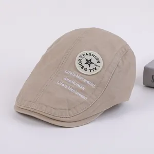 Detail view of a stylish khaki cotton flat cap with embroidery and round patch, perfect for spring.