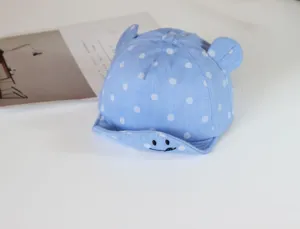 Blue baby polka dot baseball cap with cute ears and smile embroidery for infants summer wear.