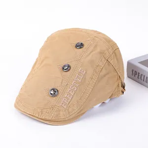 Khaki cotton flat cap with metal buttons and Freestyle embroidery for stylish streetwear outfits.