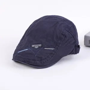 Men's dark blue cotton flat cap, casual ivy beret hat with stylish metal badge detail.