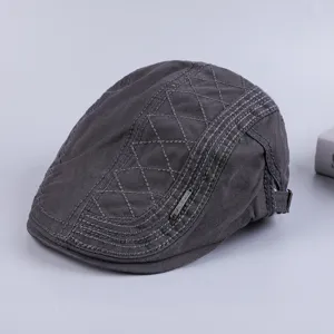 Classic mens dark gray cotton flat cap with stylish diamond stitching and metal badge detail.