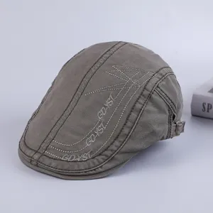 Detailed view of the dark grey cotton flat cap with stylish embroidery and texture.