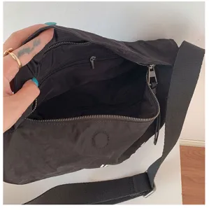 Vista dettagliata dell'interno della borsa a mezzaluna in nylon nero con tasca.