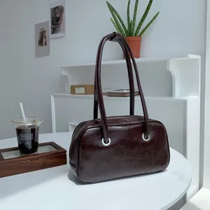 Detailed view of retro brown oil-wax leather shoulder bag, chic minimalist daily accessory style.
