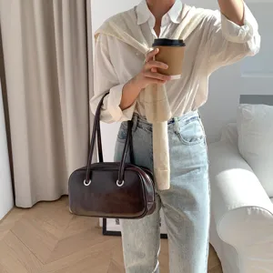 Detailed view of retro brown oil-wax leather shoulder bag, chic daily accessory lifestyle shot.