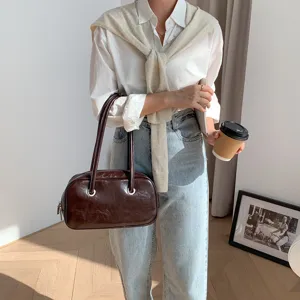 Retro oil-wax texture leather shoulder bag for women, chic Boston pillow bag with metal rings.