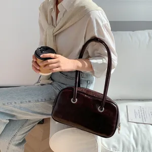 Retro oil-wax texture shoulder bag detail, stylish brown Boston pillow handbag for women.