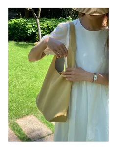 Detail shot of the minimalist soft leather shoulder tote bag, showcasing its large capacity.
