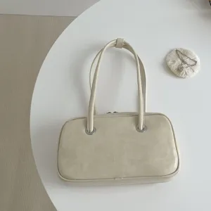 Close-up detail of a retro oil-wax texture shoulder underarm bag on clean white surface.