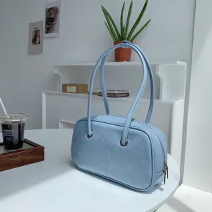 Light blue vintage oil-wax texture underarm shoulder bag for women, chic Boston handbag detail.