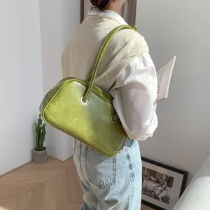 Detail view of the vintage oil-wax green underarm shoulder bag, stylish retro chic design.