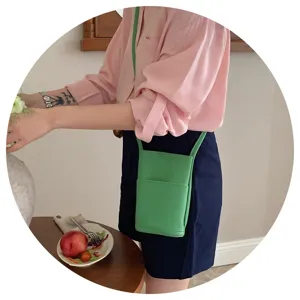 Casual green crossbody bag for women, minimalist vertical design with card pocket and slim strap.