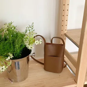 Brown PU leather mini crossbody phone bag detail view, casual card slot shoulder purse style.
