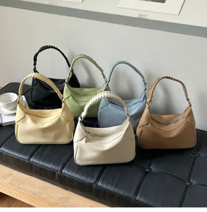 Detailed view of trendy minimalist hobo shoulder bags with braided handle in multi colors.