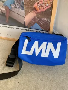 Waterproof blue crossbody bag detail, trendy big LMN letter pillow bag for daily casual use.