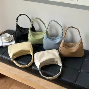 Detail view of chic minimalist woven handle shoulder bags in multiple colors, elegant fashion.