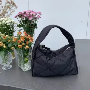Black quilted nylon hobo tote bag, casual lightweight shoulder bag with zipper closure.