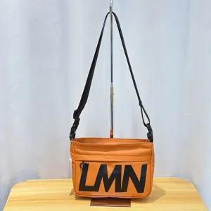 Trendy orange crossbody bag with bold LMN letters, waterproof pillow bag style for casual sports.