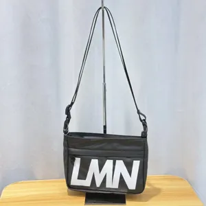 Black waterproof crossbody shoulder bag detail showcasing large white LMN letters design.