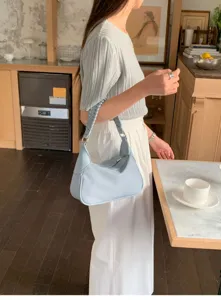 Minimalist light blue hobo shoulder bag with braided handle for women daily stylish look.