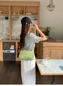 Minimalist light green shoulder underarm bag detail, stylish everyday accessory for women.