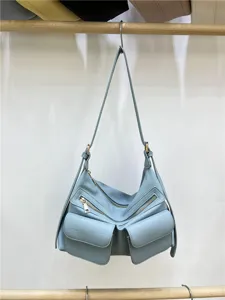 Light blue motorcycle shoulder bag detail, utility style crossbody bag, double zipper pockets.