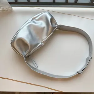 Silver metallic pleated shoulder bag for women, trendy soft crossbody bag with wide strap.