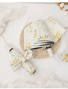 Floral folding umbrella with black UV protection lining, fresh yellow flower parasol detail.