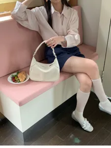 Stylish minimalist white shoulder bag for women, elegant crescent hobo handbag for daily wear.
