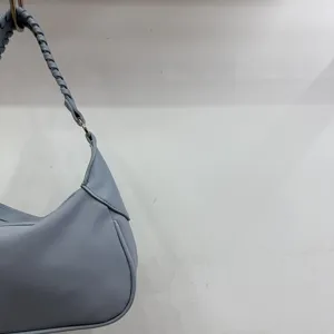 Light blue stylish shoulder handbag for women featuring a chic braided strap and minimalist design.