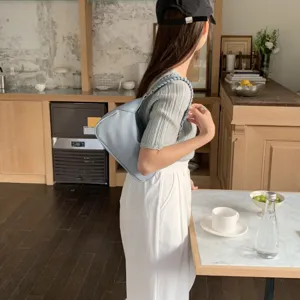 Minimalist light blue shoulder bag for women, chic hobo handbag with braided strap, daily style.