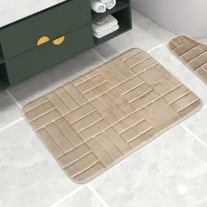Memory foam bathroom mat detail shot showing soft flannel and anti-slip brick embossed design.
