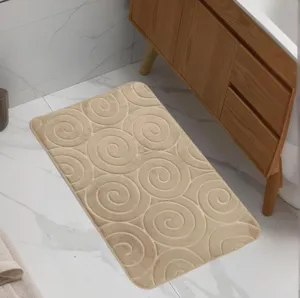 Beige flannel swirl embossed bathroom floor mat, absorbent and anti-slip bath rug.