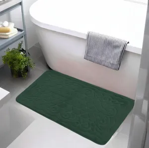 Green flannel embossed bath mat, soft and absorbent floor rug for bathroom detail.