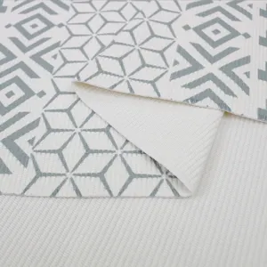 Detailed view of Nordic geometric woven cotton rug texture, highlighting soft fabric and backing.