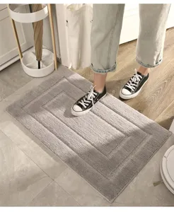 Grey absorbent bath mat with plush textured design, anti-slip floor mat for home doorway.