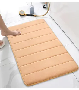 Absorbent memory foam bath mat with striped design, soft anti-slip floor rug for bathroom use.