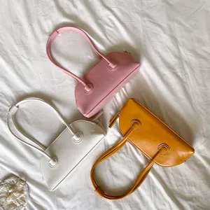 Detailed view of trendy baguette shoulder bags featuring sleek long straps and vibrant colors.