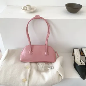 Pink underarm shoulder bag for women, stylish long handle purse, minimalist shell handbag.